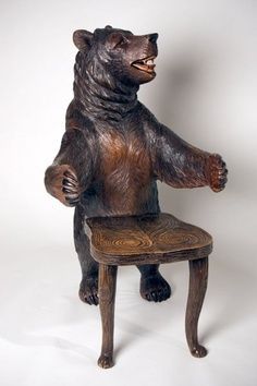 a brown bear sitting on top of a wooden chair