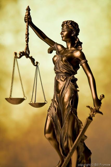 a statue of lady justice holding the scales of justice