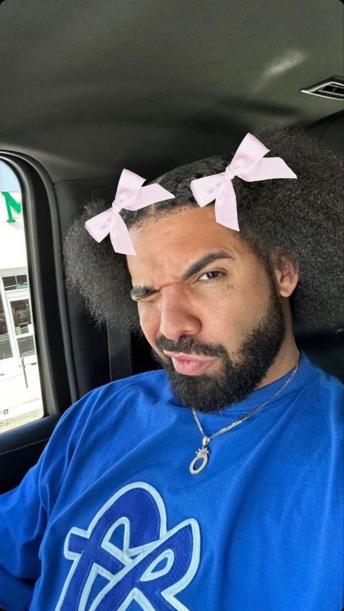 a man with two bows on his head sitting in the back seat of a car