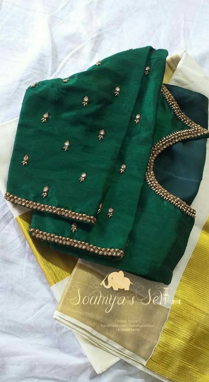 green and gold saree with matching blouses on top of each other, sitting on a white sheet