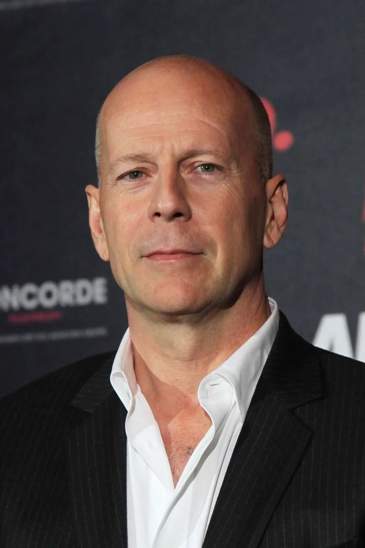 a bald man wearing a suit and white shirt