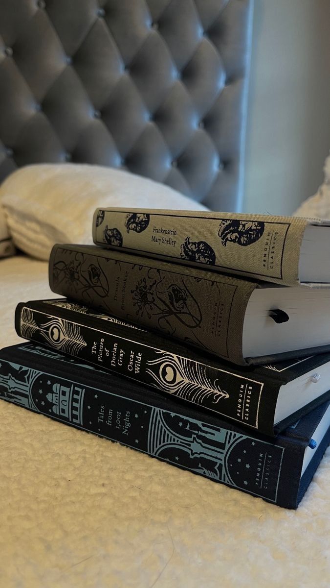 three books are stacked on top of each other in front of a white headboard