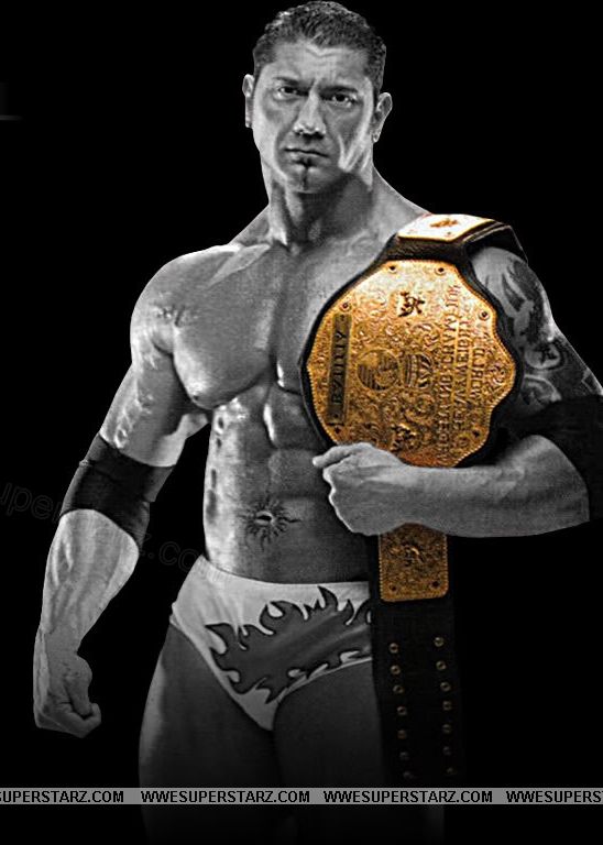 a man holding a wrestling belt in his hand