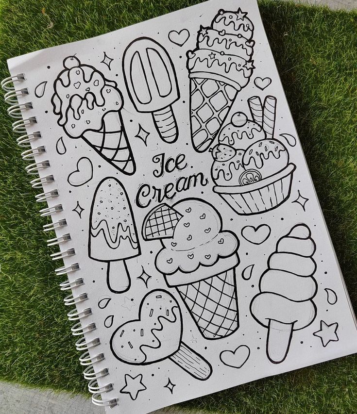 a coloring book with ice cream on it sitting in the grass next to a sidewalk