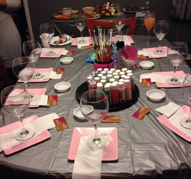 the table is set with pink napkins and place settings for an elegant dinner party