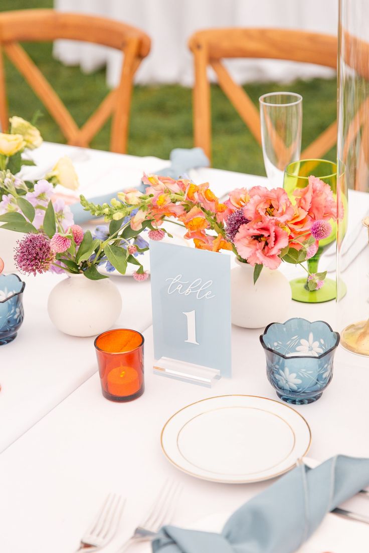 the table is set with flowers and place settings for an elegant wedding breakfast or brunch