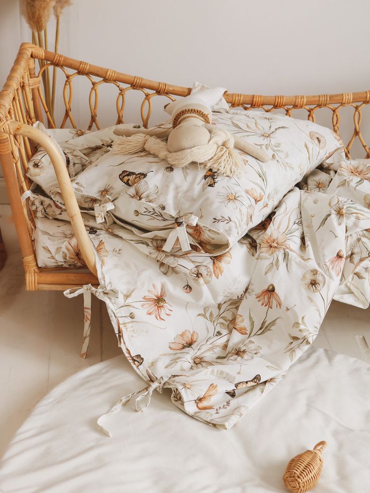 an unmade bed covered with blankets and pillows