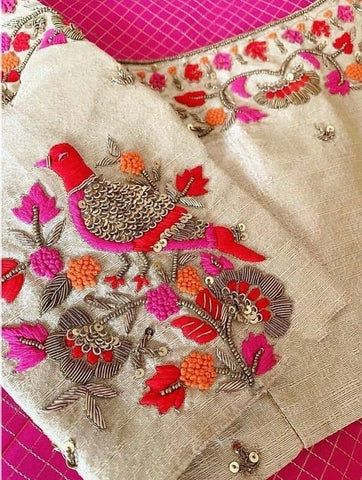 an embroidered shirt with birds and flowers on it