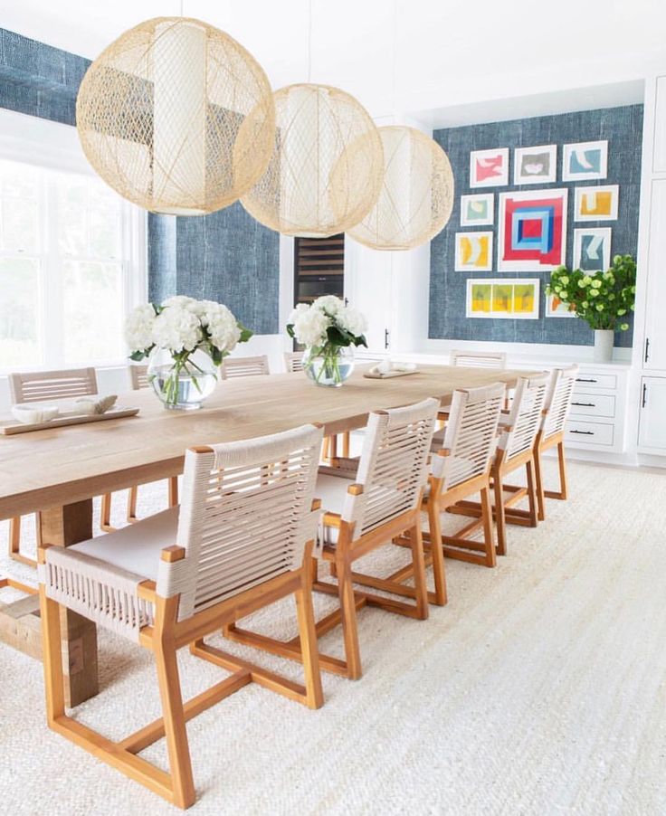 a dining room table with chairs and chandelier hanging from the ceiling