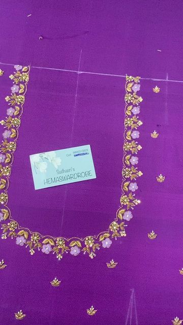 a purple dress with gold trim and flowers on it's chest, along with a name tag