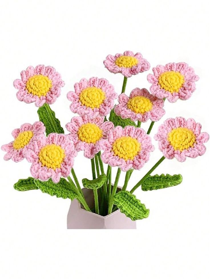 pink and yellow crocheted flowers in a white vase