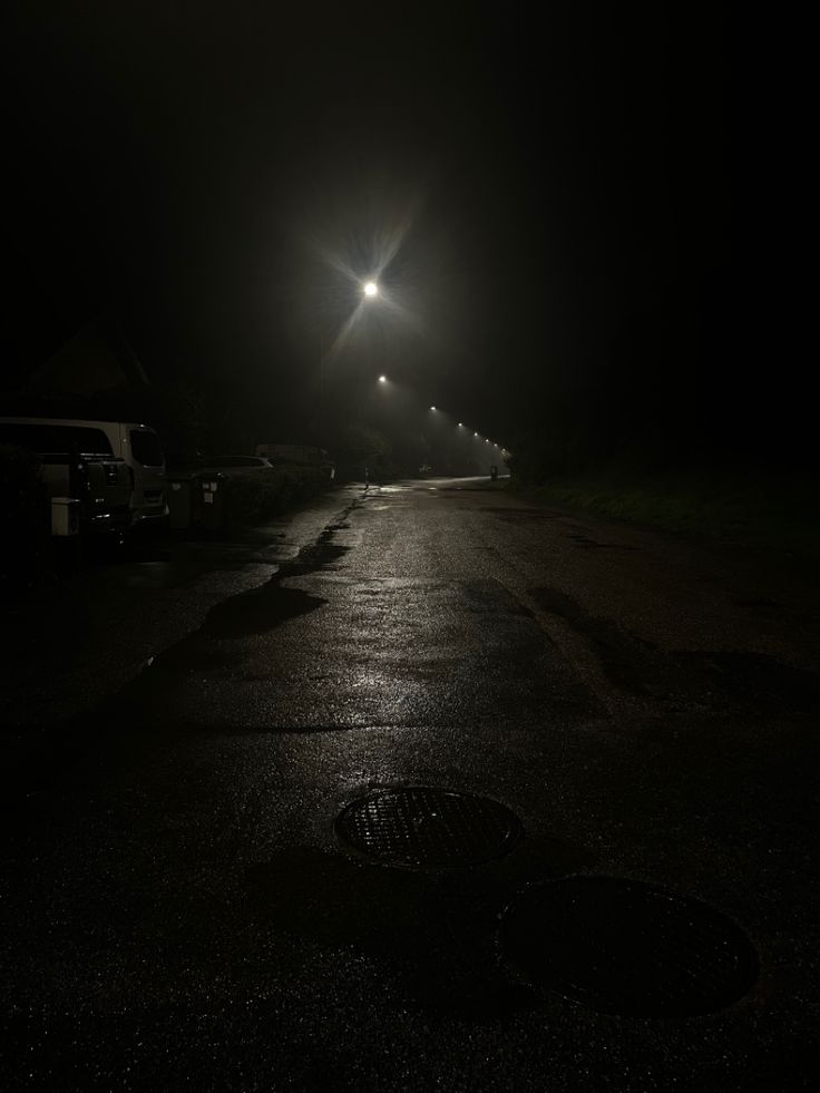 an empty street at night with the lights on