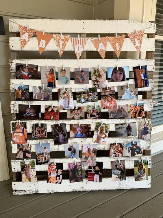 an old pallet is decorated with photos and bunting