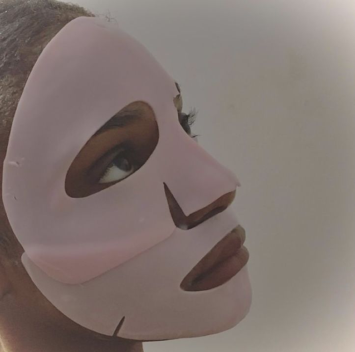 a woman with a pink mask on her face