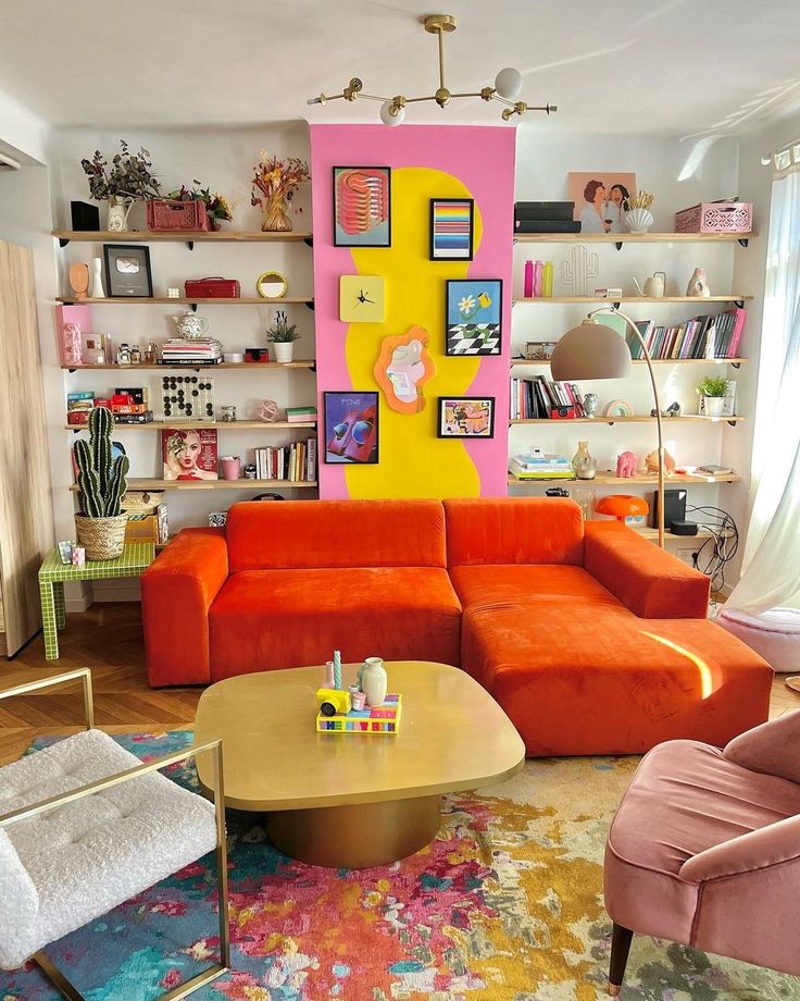 a living room filled with lots of furniture and walls painted pink, yellow, and orange