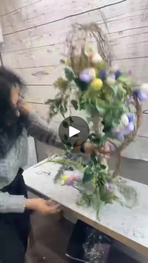 the woman is arranging flowers on the table