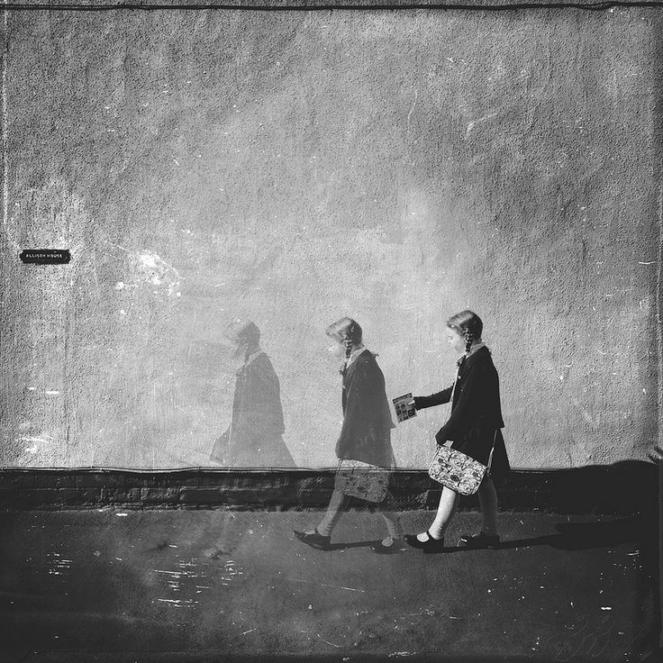 two women are walking down the street holding hands