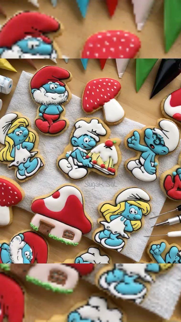 the smurfs cookies are decorated with different colors and designs, including one for each cookie