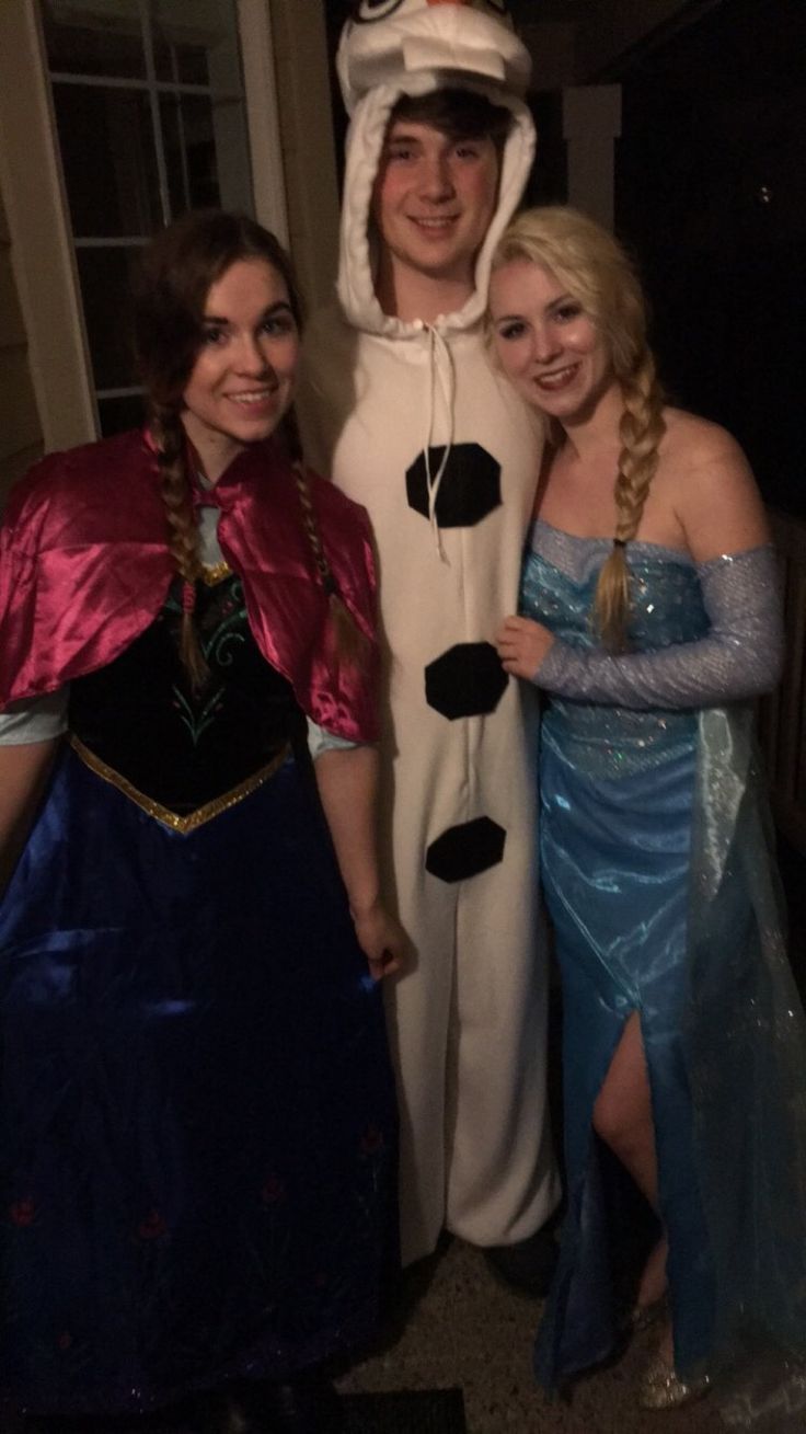 three people in costumes posing for a photo