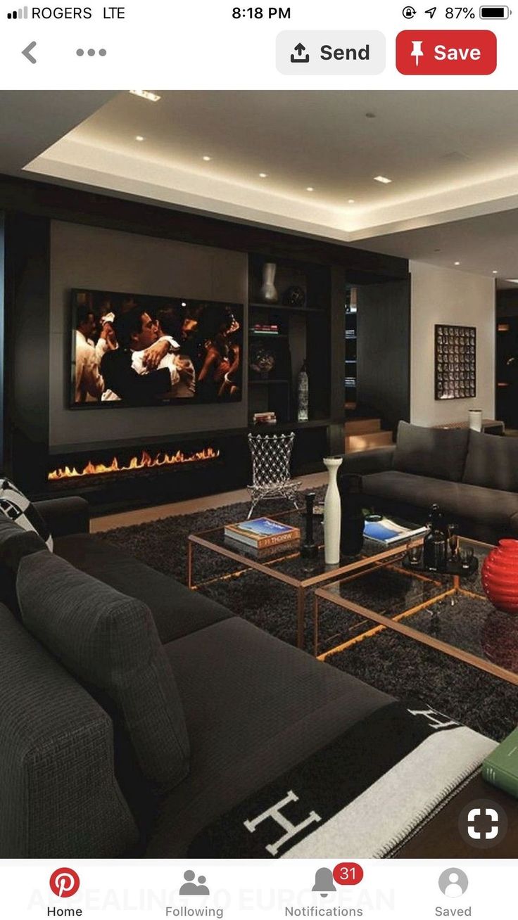 a living room filled with furniture and a flat screen tv mounted to the side of a wall