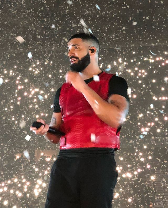 a man with a beard standing in front of snow flakes and confetti