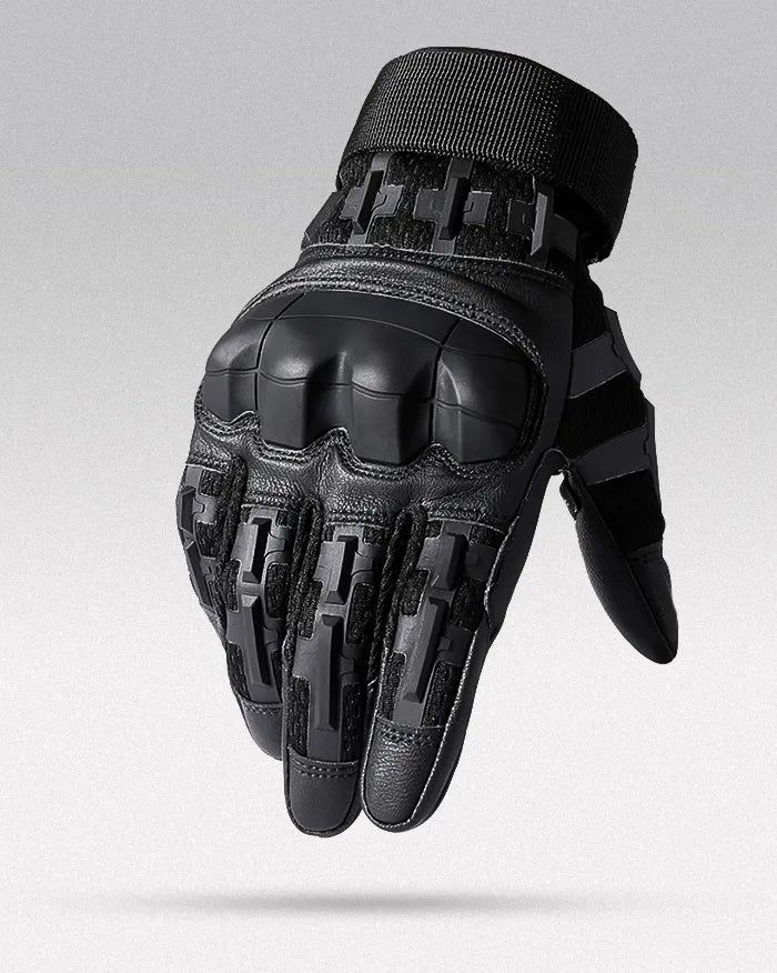 a pair of black motorcycle gloves on top of each other in front of a gray background