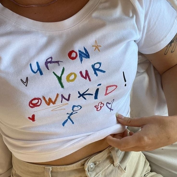 a person wearing a white shirt with writing on it