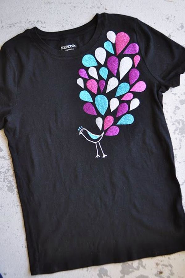 a black t - shirt with colorful feathers on it