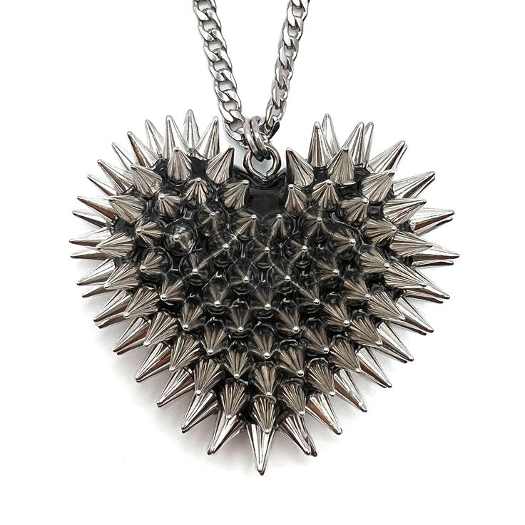 Meet your new favorite statement piece. The Spiked Heart Necklace is a Bunny Paige classic that’s the perfect edgy statement necklace. This full-size iconic handcrafted resin heart has over 100 individually hand-applied spikes in your choice of silver or gold. A bestselling, Bunny Paige classic. DETAILS Heart Charm: 2" wide Chain: stainless steel or gold plated SIZE CHART 2010 Jewelry, Spikes Fashion, Grunge Necklace, Spiked Jewelry, Cool Ear Piercings, Goth Accessories, Edgy Jewelry, Resin Heart, Big Jewelry