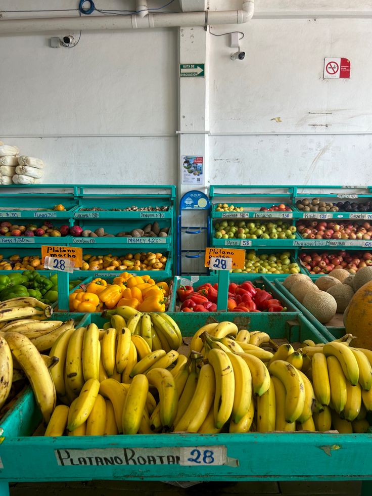 there are many different fruits and vegetables on display in the market area, including bananas