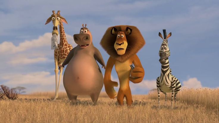 the animals are standing around in the field with zebras and giraffes