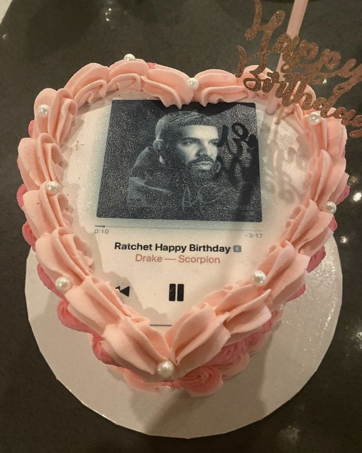 a heart shaped cake with a photo on it