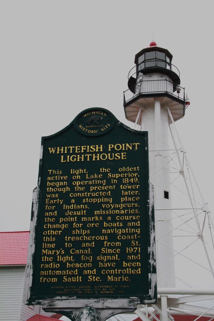 a sign that is in front of a light house