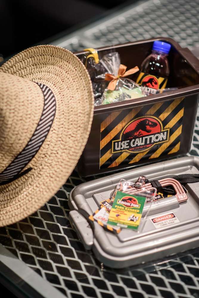 a straw hat sitting on top of a table next to a container with various items in it