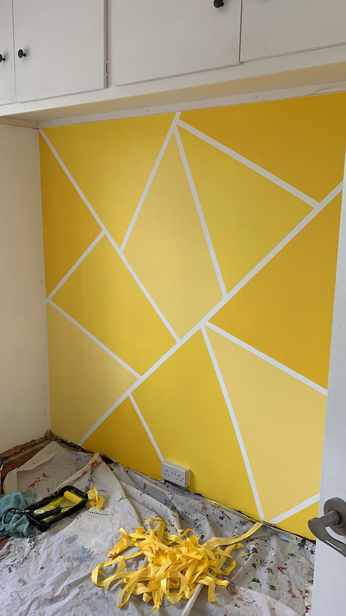 the wall is being painted yellow and white