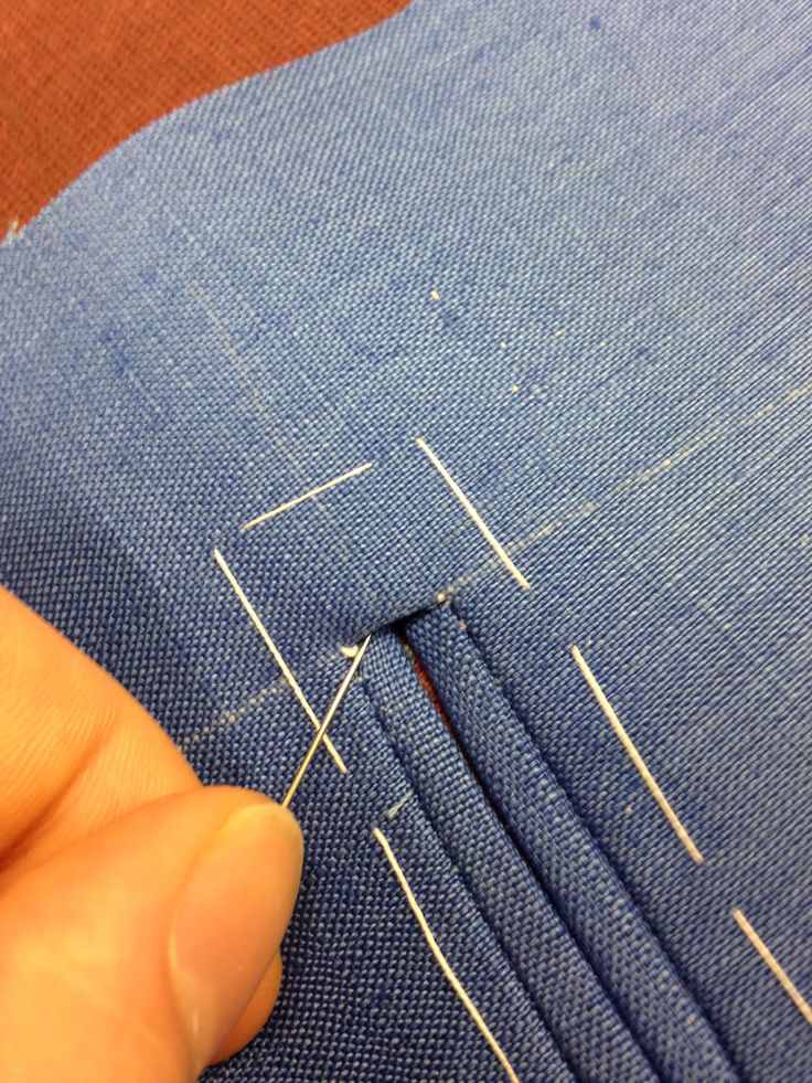 someone is stitching together some fabric with scissors