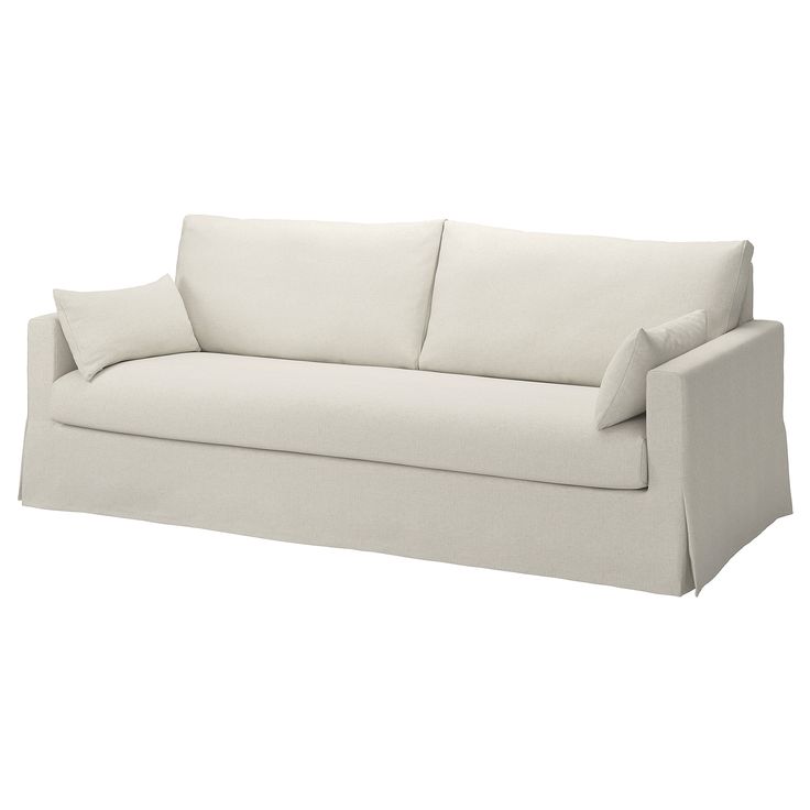 a white couch with two pillows on it