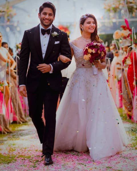 a bride and groom walking down the aisle