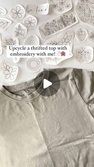 a t - shirt with the words upcycled on it, surrounded by buttons and magnets