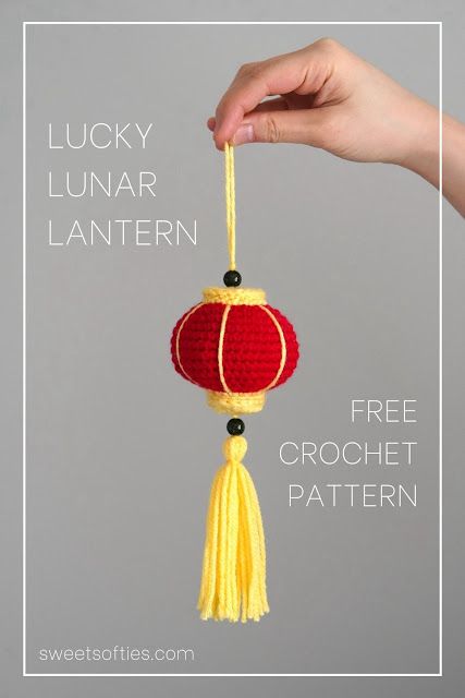 a hand holding a red and yellow chinese lantern ornament with text that reads lucky lunar lantern free crochet pattern