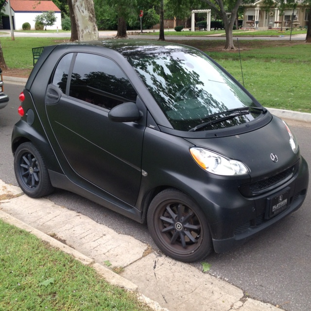 a smart car parked on the side of the road