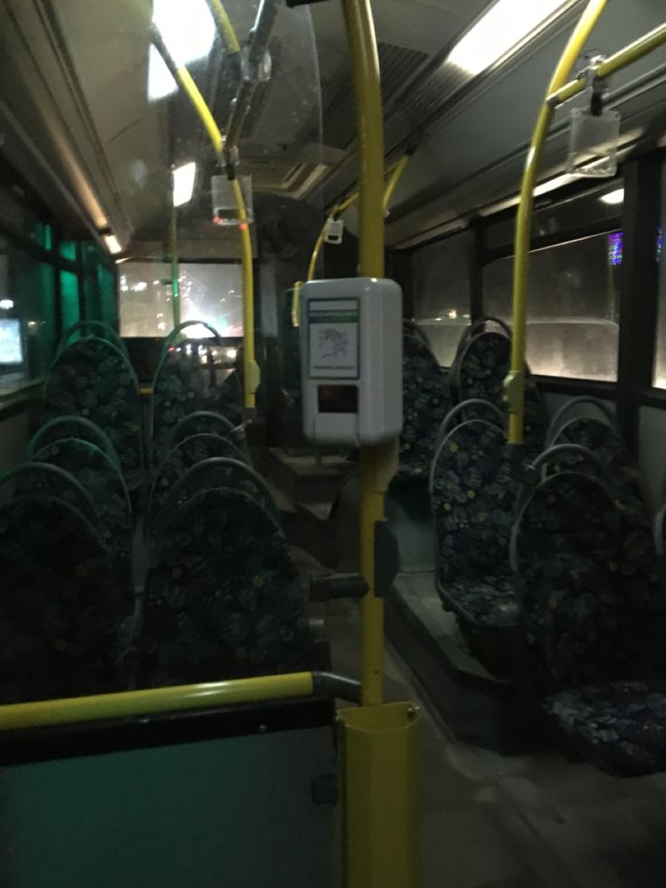 the interior of a subway car with many seats