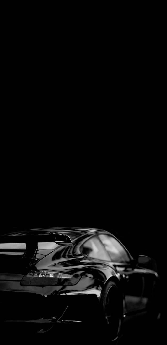 a black and white photo of a car in the dark