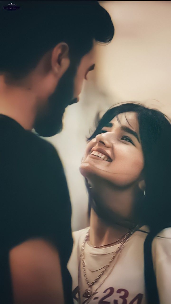 a man standing next to a woman with her eyes closed and smiling at the camera