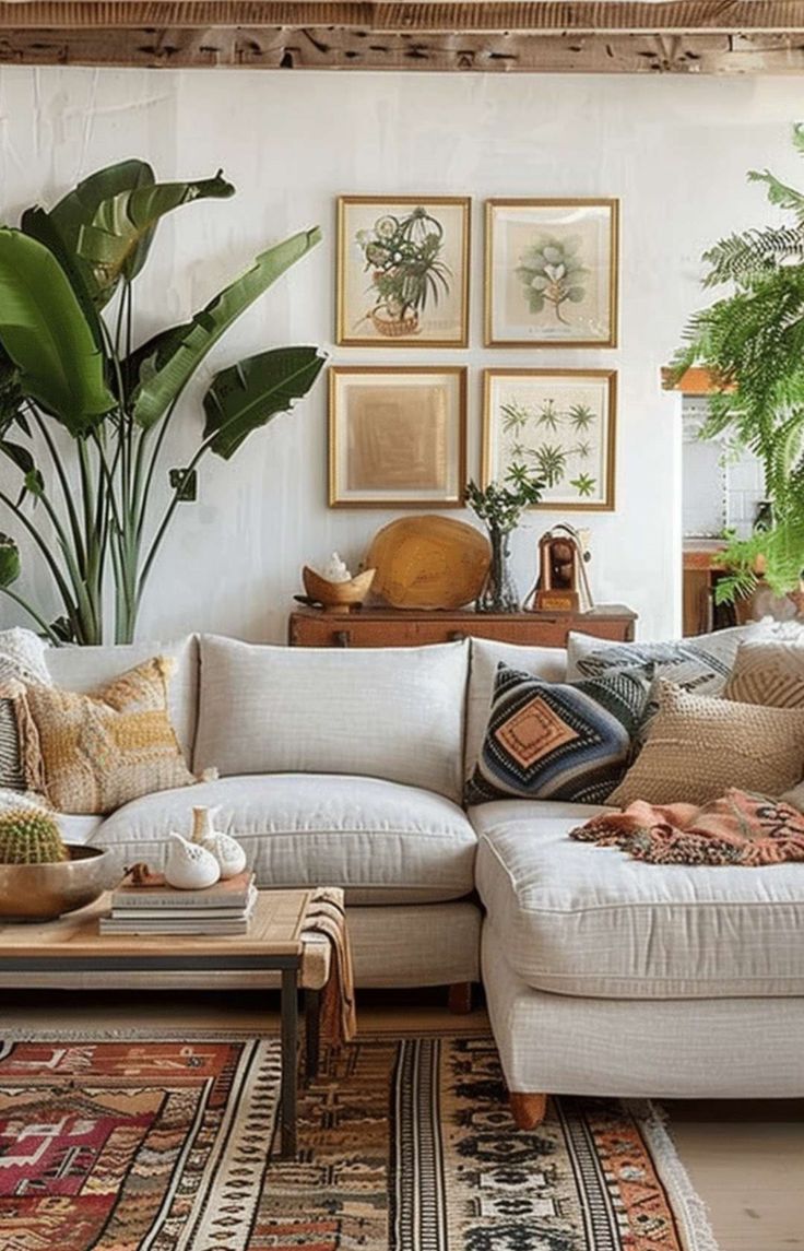 a living room filled with lots of furniture and plants on the wall above it's couch