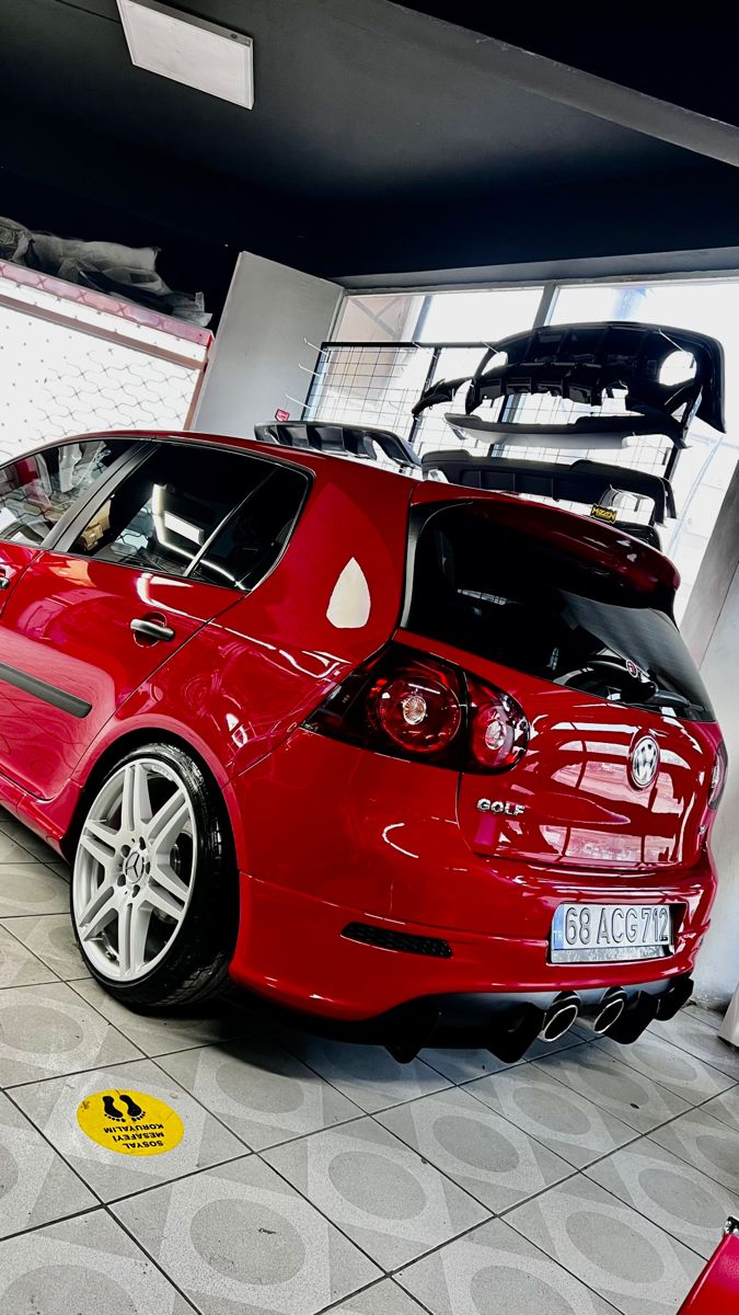 a red car is parked in a garage