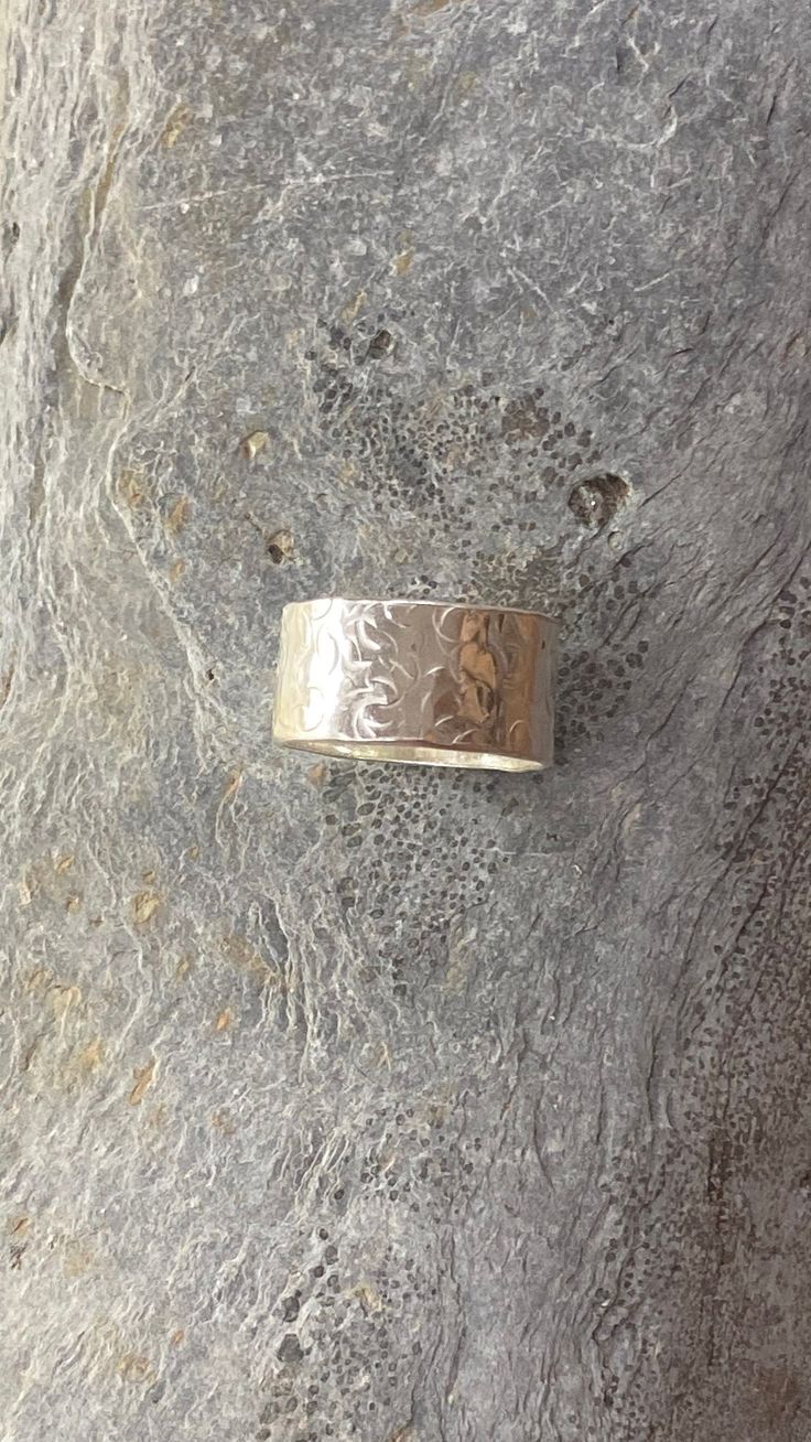 Sterling Silver Wide Band Patterned Ring Hand crafted for a unique Bohemian style, this unisex Silver Wide Band Ring is made with eco-friendly, recycled sterling silver and features a delicate patterned finish. At 10mm wide, it makes a great his and hers ring, perfect for any occasion. Handmade  in Woolacombe, North Devon. Artisan Jewellery.  A timeless simple classic ring. With an understated style and beautiful finish   The ring is handmade to order.  Comes gift boxed.  https://silverlinesjewe Textured Jewellery, His And Hers Ring, His And Hers Rings, Dope Jewelry Accessories, Wide Silver Ring, Silver Spoon Ring, Soft Pattern, Understated Style, Hammered Silver Ring