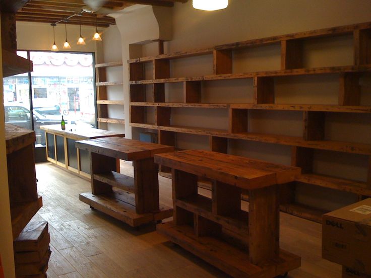 an empty room with wooden shelves and benches