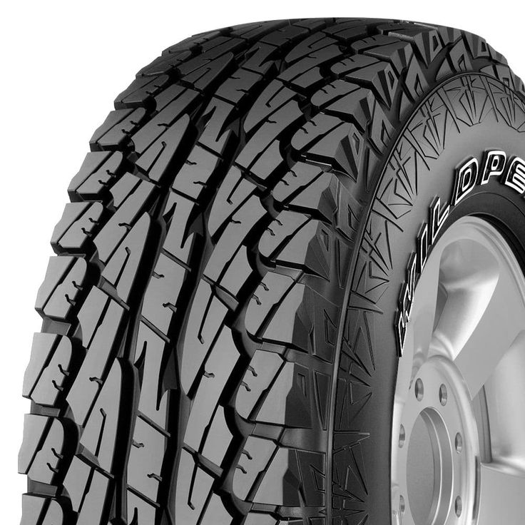 an all terrain tire on a white background