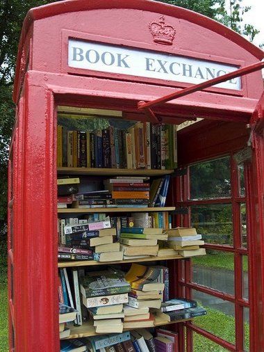 a red phone booth with books in it